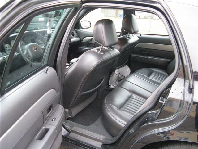 2003 Mercury Marauder interior showing front and rear black leather seats, dashboard, and door panels