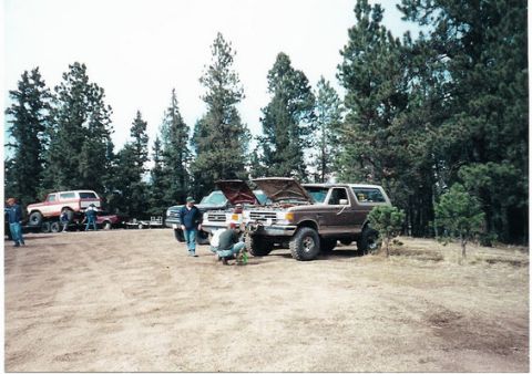 1996 Ford Bronco - Several vehicles are gathered outdoors with their hoods up, suggesting maintenance or a meet-up.