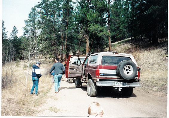 Maroon and white SUV with spare tire on rear, 1996 Ford Bronco