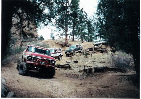 1996 Ford Bronco - Several Ford Broncos navigate a challenging off-road course.