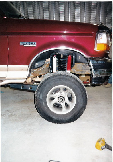 1996 Ford Bronco - Close-up of a 1996 Ford Bronco's front suspension during a lift installation.