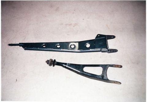 1996 Ford Bronco - Two suspension control arms, likely for a lift kit installation, are shown laid out on a flat surface.