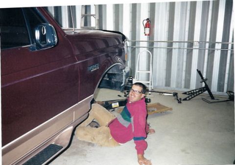 1996 Ford Bronco - Man working on a 1996 Ford Bronco in a garage setting.