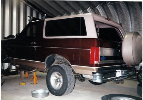 1996 Ford Bronco - This 1996 Ford Bronco is shown from the rear, elevated on jack stands for service.