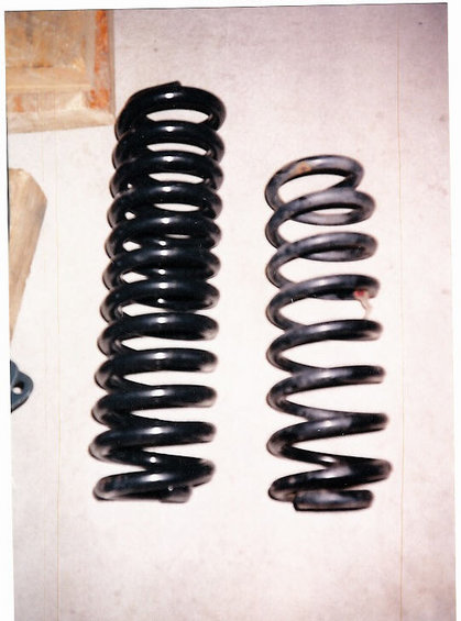 1996 Ford Bronco - Comparison of two coil springs, likely for suspension modification. Supermotors.net logo visible.