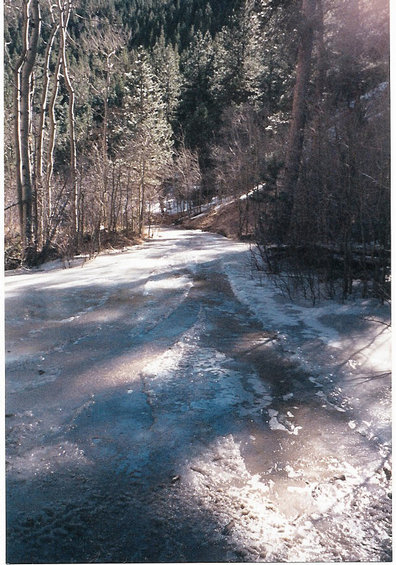 1996 Ford Bronco - Icy mountain road with trees and snow, likely a winter scene.