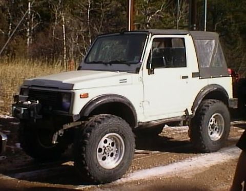 1996 Ford Bronco - This Suzuki Samurai features a lifted suspension and aftermarket wheels, ready for off-road adventures.