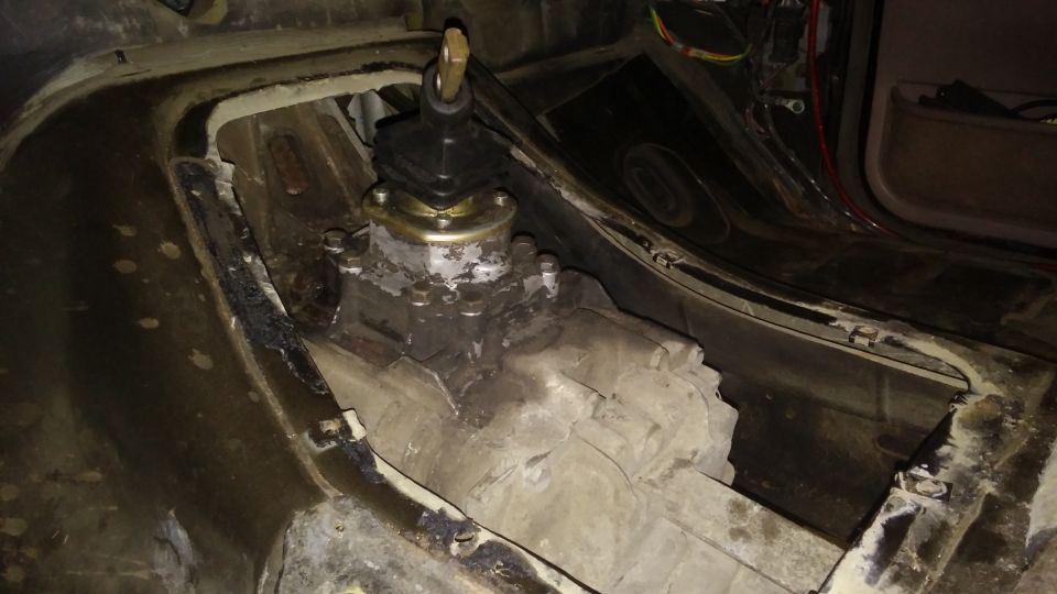 Manual transmission shifter assembly installed in a vehicle's floor pan