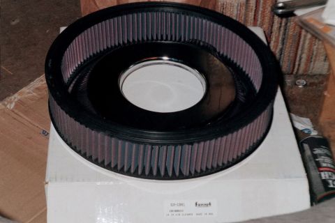 1979 Ford Bronco - A black air filter with purple filter media is shown on top of its packaging, with a can of spray to the side.