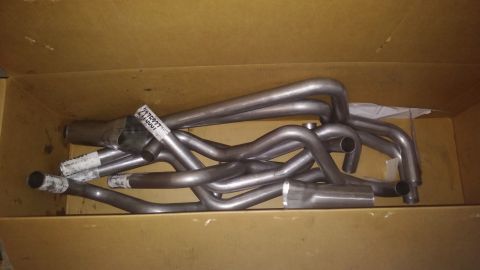 1995 Ford Bronco - A set of exhaust headers are pictured inside a cardboard box, with a visible part number label.