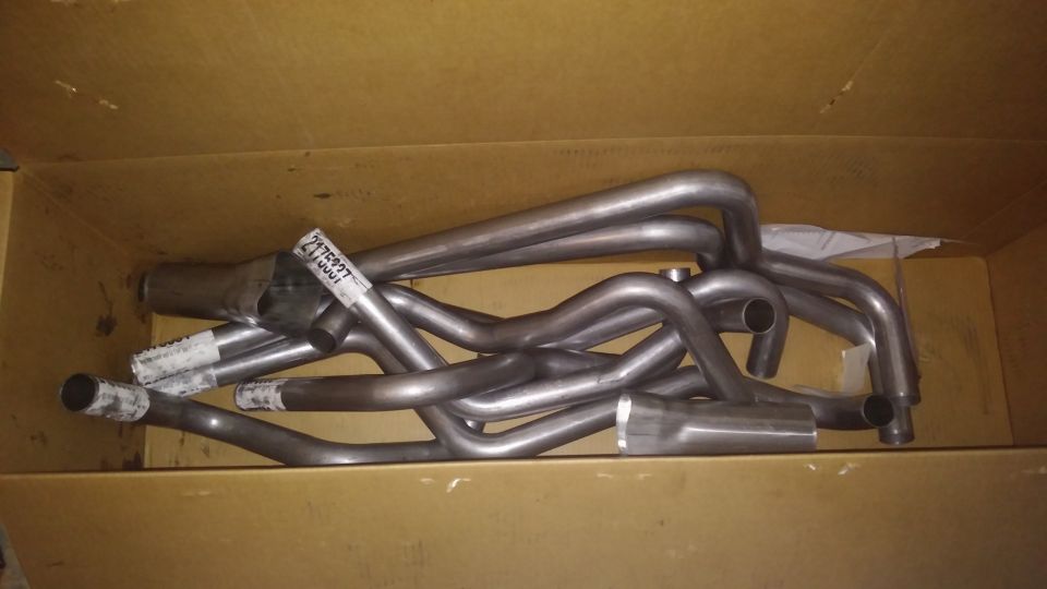 Exhaust headers in a cardboard box with a label reading 2175937