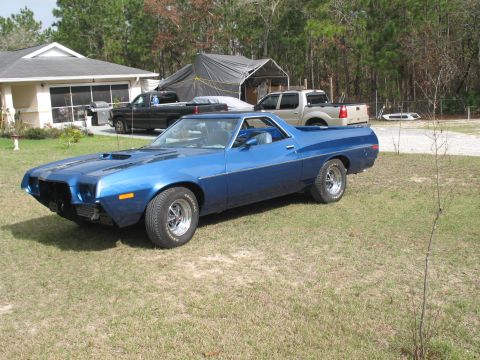 1972 Ford Ranchero - Blue 1972 Ford Ranchero with a hood scoop sits in a grassy yard.