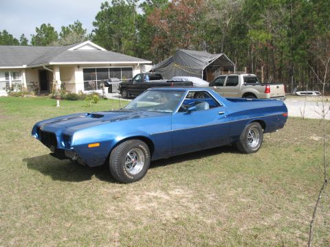 1972 Ford Ranchero - A blue 1972 Ford Ranchero sits in a yard with a house and other vehicles visible.