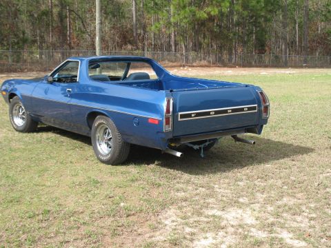 1972 Ford Ranchero - A blue 1972 Ford Ranchero is shown from the rear-left quarter angle, parked outdoors on a grassy area.