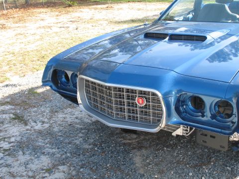 1972 Ford Ranchero - Front view of a blue 1972 Ford Ranchero, its distinctive grille and dual hood scoops.