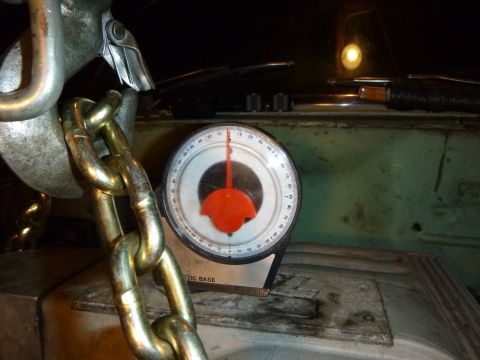1953 Plymouth Belvedere - A gauge and chain are visible in the engine bay of a vehicle.