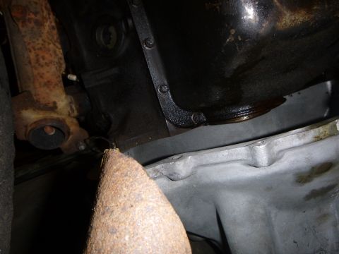 1953 Plymouth Belvedere - Underside view of a vehicle's engine oil pan and exhaust system components.