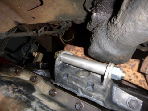1953 Plymouth Belvedere - Close-up view of a vehicle's engine mount assembly, showing mechanical components and grease buildup.
