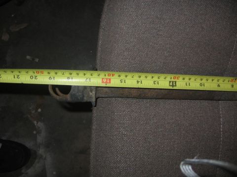 1988 Ford Bronco - A metal rod is measured with a tape measure against a gray fabric background.