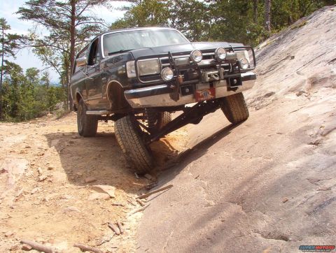 1988 Ford Bronco - This 1987 Ford Bronco navigates a challenging rocky trail, its off-road capabilities with a winch and auxiliary lights.