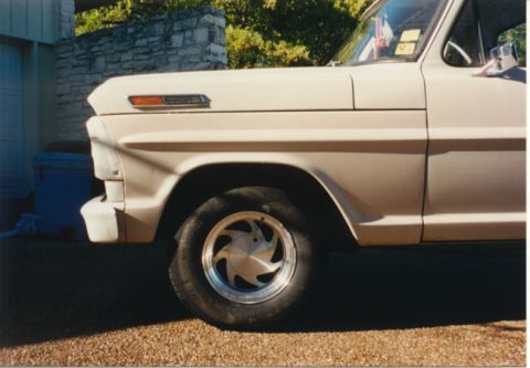 1968 Ford F-100 - A close-up of the front fender and wheel of a vintage Ford F-Series truck.