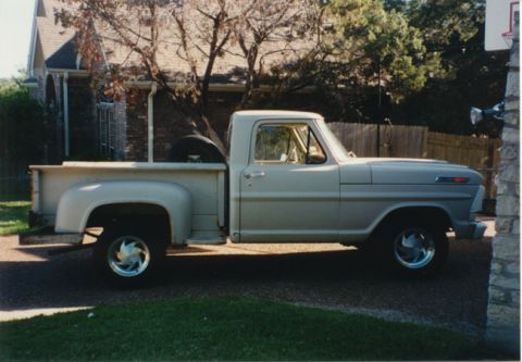 1968 Ford F-100 - This 1968 Ford F-100 pickup truck is shown from the side, parked in a driveway.