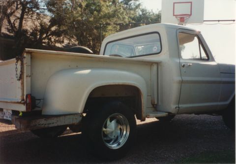 1968 Ford F-100 - Side view of a white 1968 Ford F-100 pickup truck with aftermarket chrome wheels.