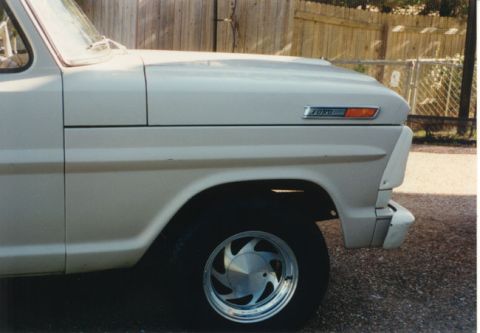 1968 Ford F-100 - Close-up of a 1968 Ford F-100 fender, highlighting the 'FORD' badge and side marker light.