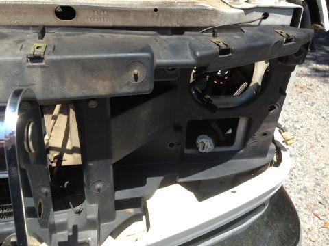 1997 Ford F-250 - A close-up view shows the front headlight assembly area of a vehicle, with some of the plastic trim and wiring visible. The vehicle appears…