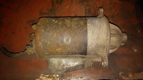 1995 Ford Bronco - A close-up view of a beige automotive part, likely from the interior of a vehicle.