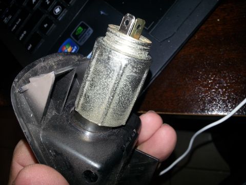 1994 Ford Bronco - Photo of a removed automotive cigarette-lighter heating element held in a hand.