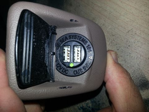 1994 Ford Bronco - Photo of a beige interior power-point fitted with a Blue Sea Systems dual-USB 12VDC charger insert.