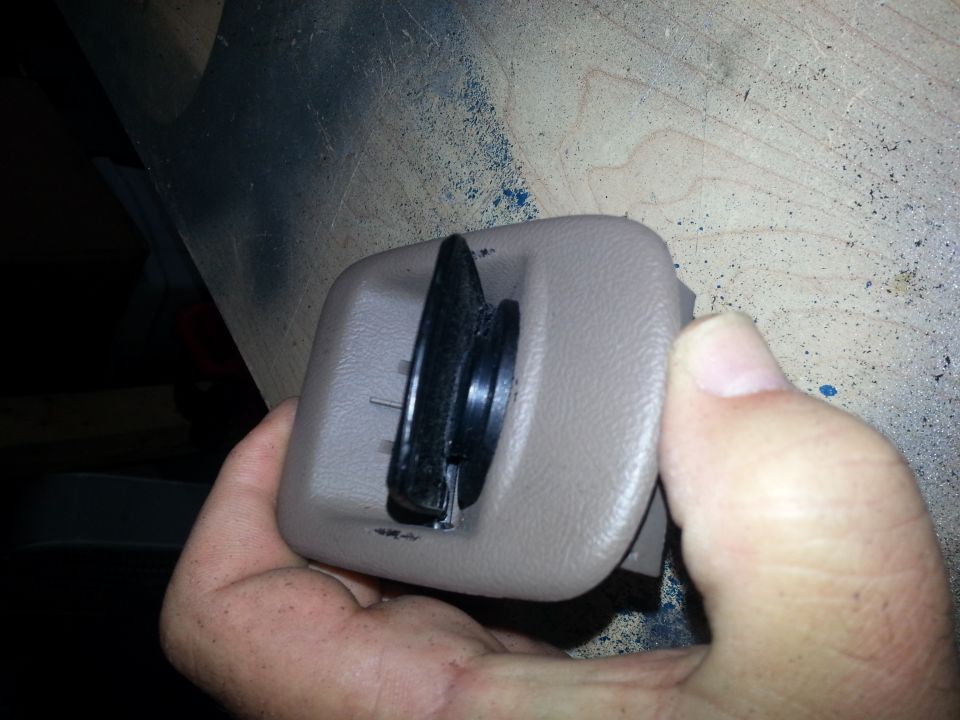 Hand holding a beige power-point housing with black rubber gasketed cap