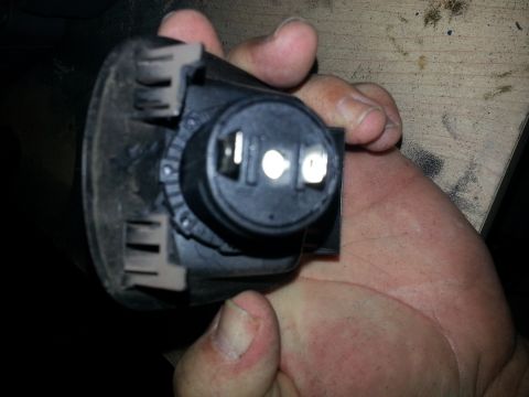 1994 Ford Bronco - Photo of the rear of a black 12V power-socket showing two metal spade terminals.