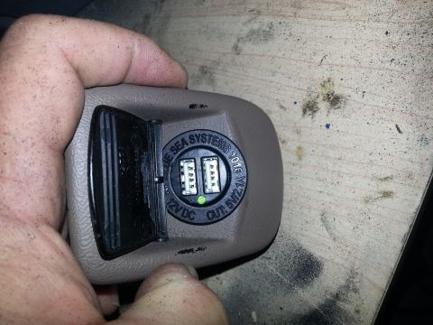 1994 Ford Bronco - Photo of a beige interior power-point fitted with a Blue Sea Systems dual-USB 12VDC charger.