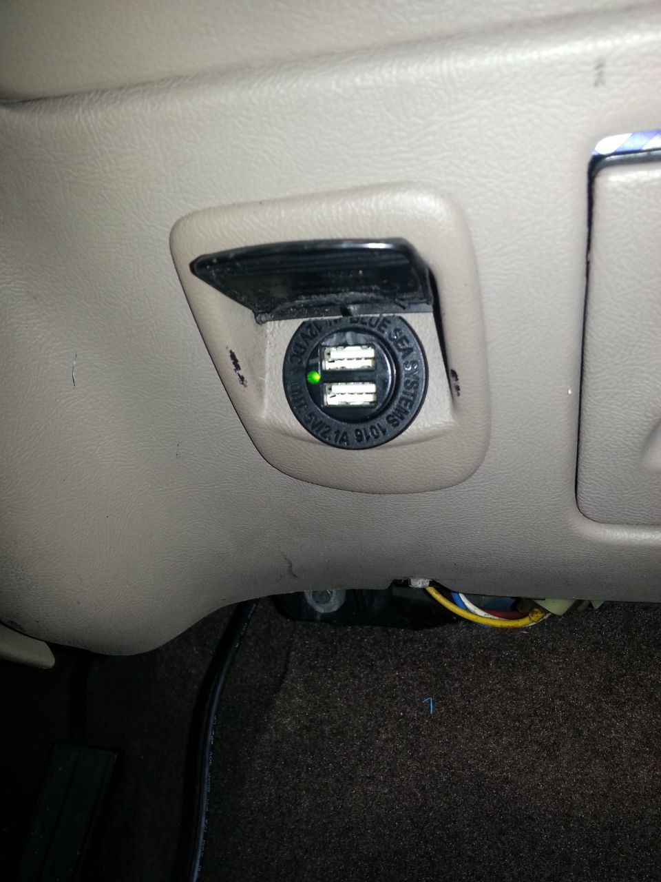 Tan dashboard with installed Blue Sea Systems dual-USB power-point charger