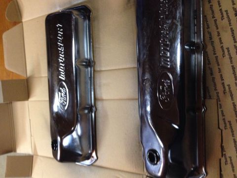 1979 Ford Bronco - Two dark, glossy Ford Motorsport valve covers are displayed in a cardboard box. The valve covers have raised Ford oval logos and lettering.