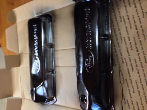 1979 Ford Bronco - Two black, shiny valve covers are shown in a cardboard box. The valve covers appear to be for a Ford vehicle, with embossed logos visible o…