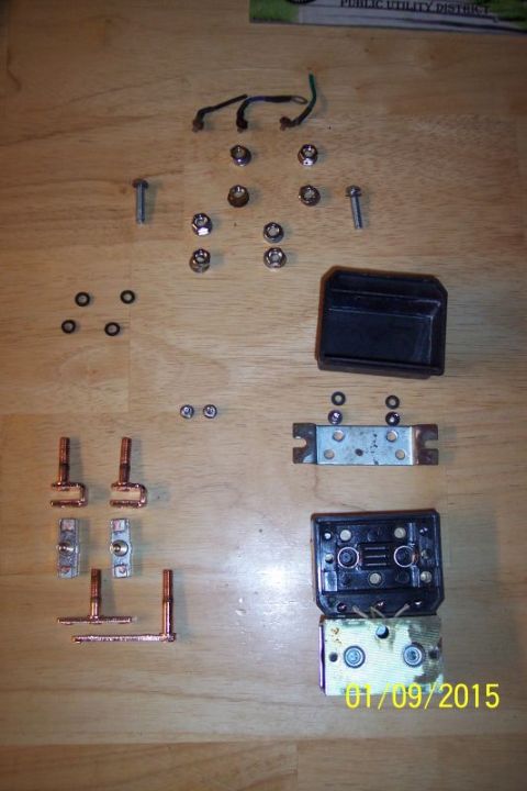 1973 Ford F-250 - A collection of disassembled electrical components and hardware, including screws, nuts, washers, copper terminals, and what appears to be…