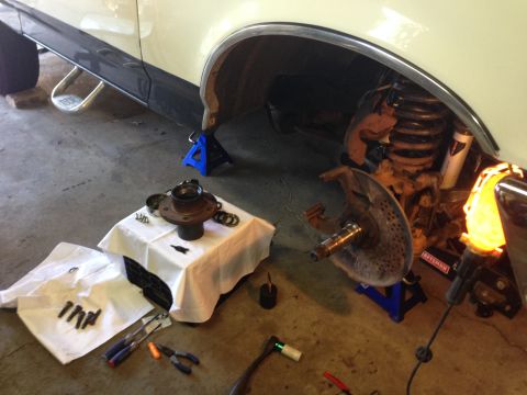 1989 Ford Bronco - Hub off and removed from old rotor. Spindle cleaned and inspected for wear. Lug bolts removed and cleaned on the wire wheel.
