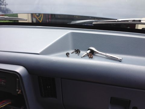 1989 Ford Bronco - OEM radio is held onto the brackets by 4 screws.