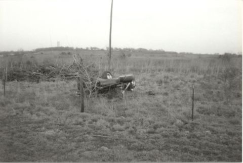 1967 Ford F-100 - A wrecked vehicle sits in a field under an overcast sky.