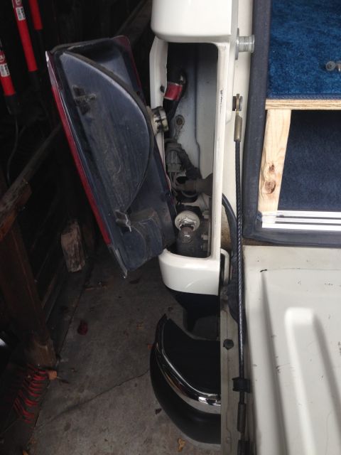 1989 Ford Bronco - 4 screws hold on the light lens. 2 on the exterior and 2 accessed once the tailgate is down. Twist the socket out of its mount in the lens.…