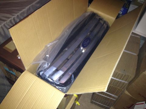 2004 Ford Crown Victoria - A new Ford grille is shown inside its shipping box, ready for installation.