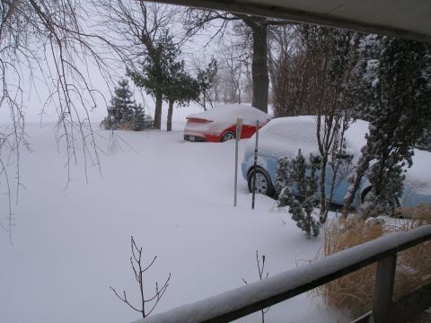 2008 Hyundai Accent - A winter scene shows two vehicles partially buried under a thick blanket of snow.
