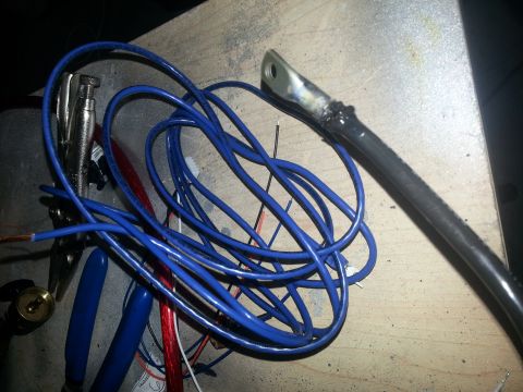 1994 Ford Bronco - Close-up of electrical wiring and tools, possibly for a car stereo installation.