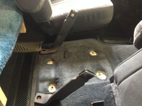 1989 Ford Bronco - Console out. Made sure to put anti-seize on the mounting threads. The bolts come through the body of the cab.
