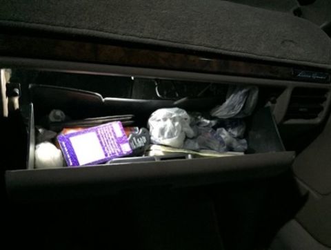 1996 Ford Bronco - Interior view of an open glove box containing assorted items.