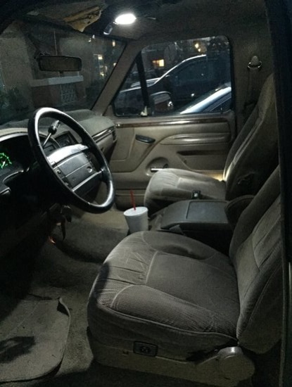 1996 Ford Bronco - The interior of a vehicle is shown, with a focus on the seats and dashboard area.