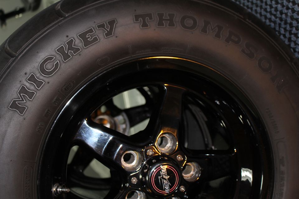 Mickey Thompson tire sidewall lettering beside a black wheel